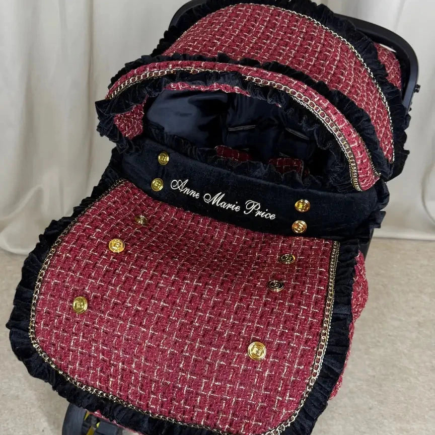 Doona+ red tweed car seat cover set with black velvet trim, gold buttons and personalized embroidery.