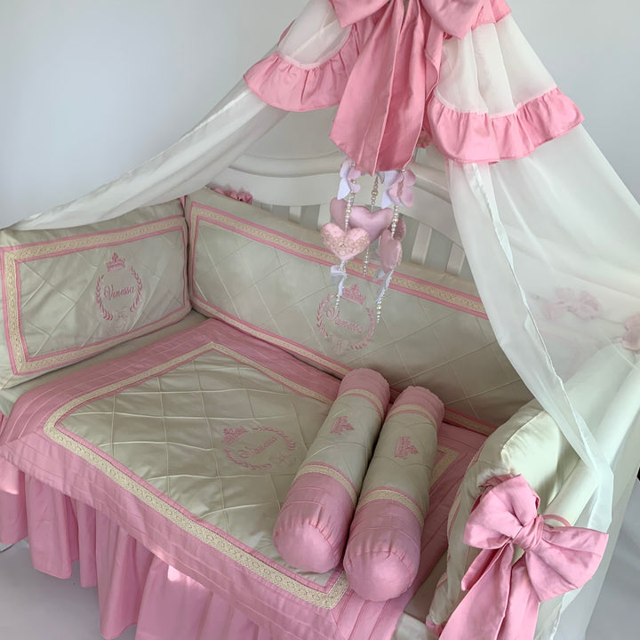 Custom pink crib skirt and matching padded bumpers for baby girl nursery