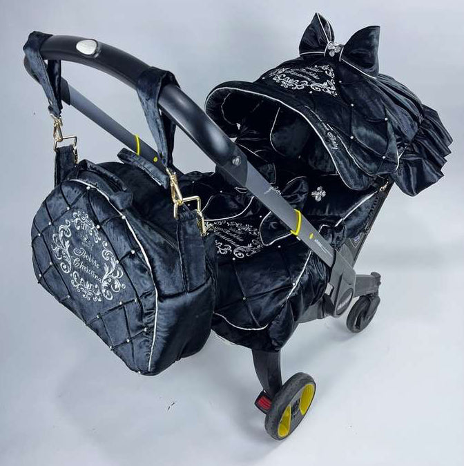 Black stroller with decorative elements on a white background