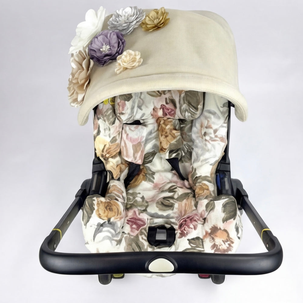 Front view beige floral Doona car seat cover with 3D flower canopy.