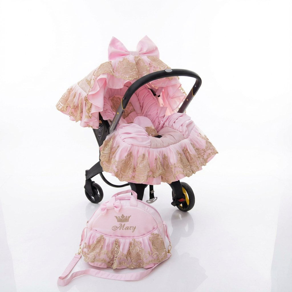 Luxury pink baby car seat cover set with gold lace, ruffled design, matching hood, footmuff, and personalized diaper bag