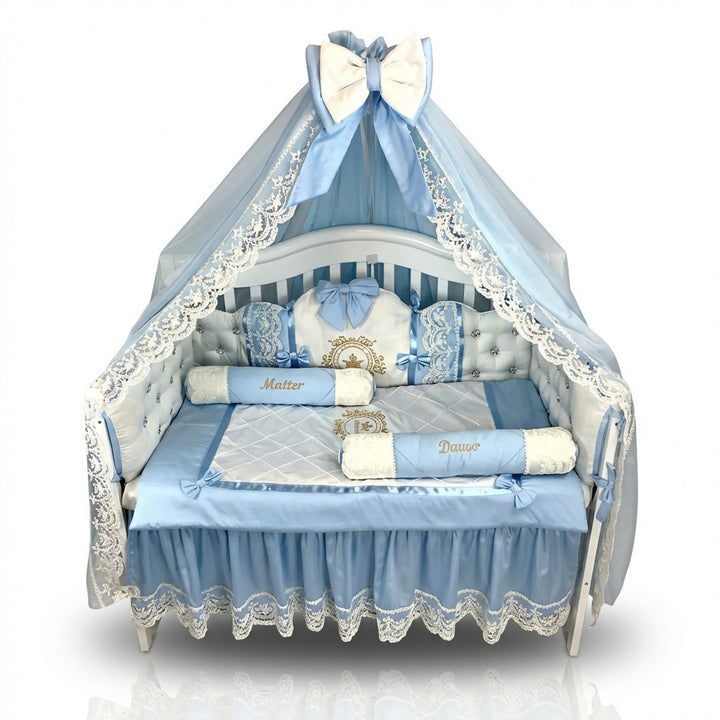 Baby crib with blue and white bedding and canopy on a white background
