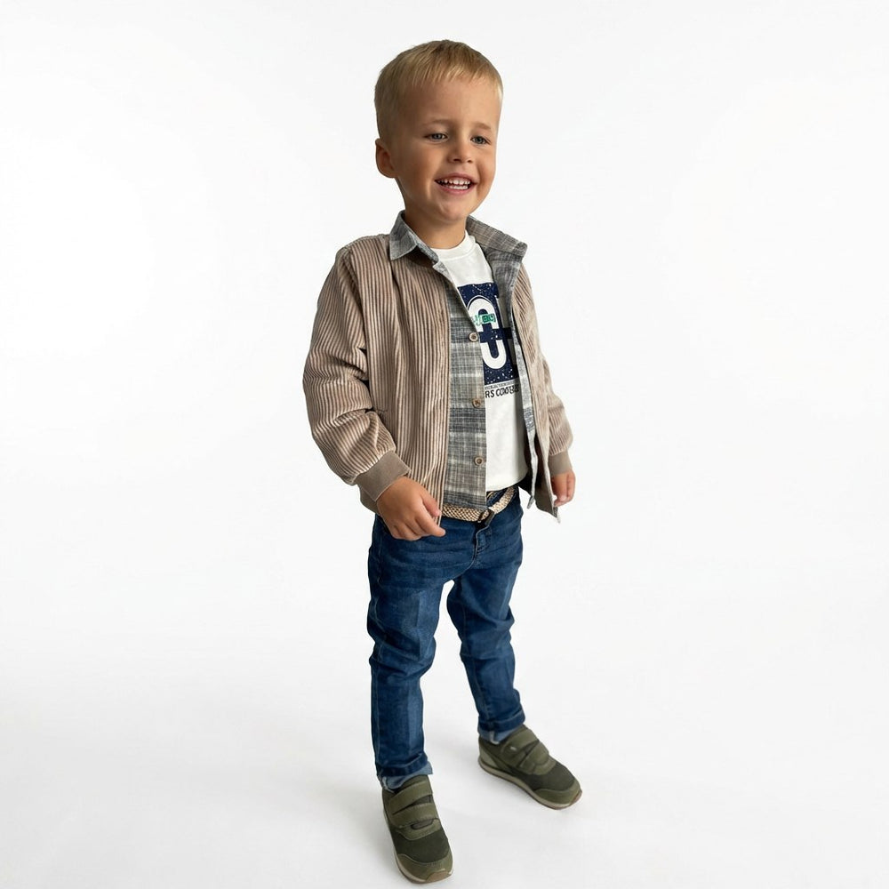 Young boy wearing a layered outfit with a plaid shirt, denim jeans, and brown shoes on a white background