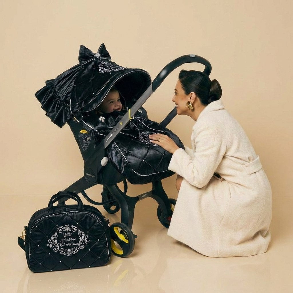Elegant lifestyle scene with mother and baby styled with black stroller cover set