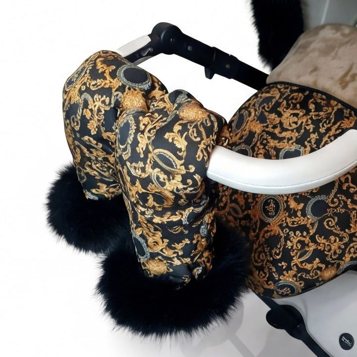 Close-up of luxury patterned stroller mittens with natural arctic fur trim attached to a stroller handle.