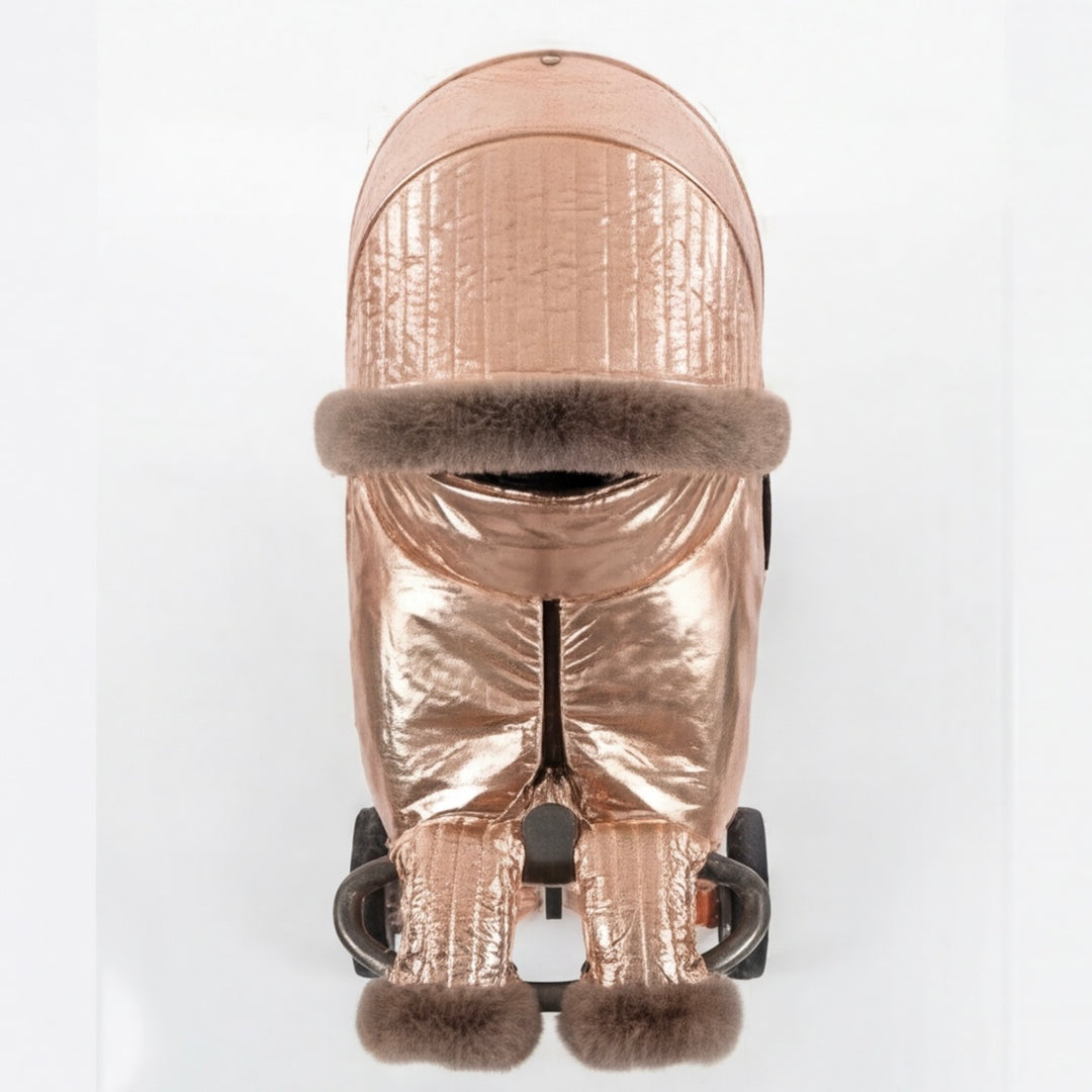 Front view of a rose gold metallic stroller cover set with quilted canopy, arctic fox fur trim, matching footmuff, and mittens, displayed on a stroller frame against a white background.