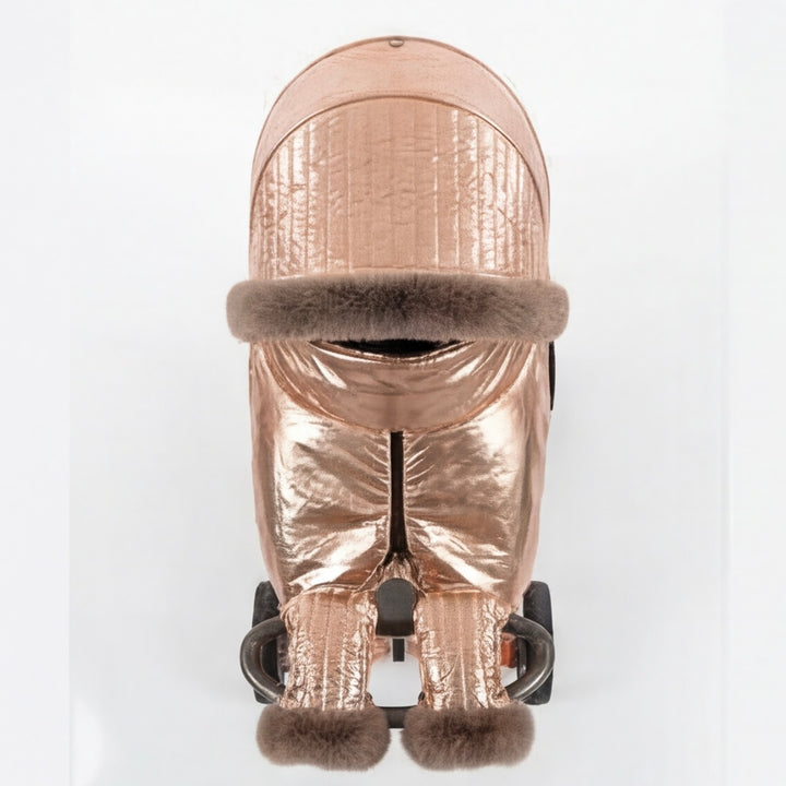 Front view of a rose gold metallic stroller cover set with quilted canopy, arctic fox fur trim, matching footmuff, and mittens, displayed on a stroller frame against a white background.