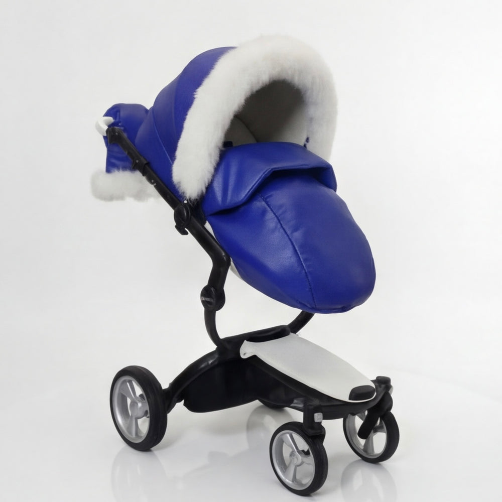 Side view of a blue stroller cover footmuff with white arctic fox fur trim, displayed on a stroller frame against a white background.