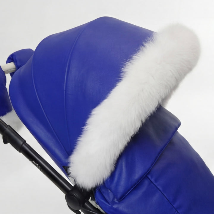 Close-up of a blue stroller cover canopy trimmed with white arctic fox fur, shown against a white background.