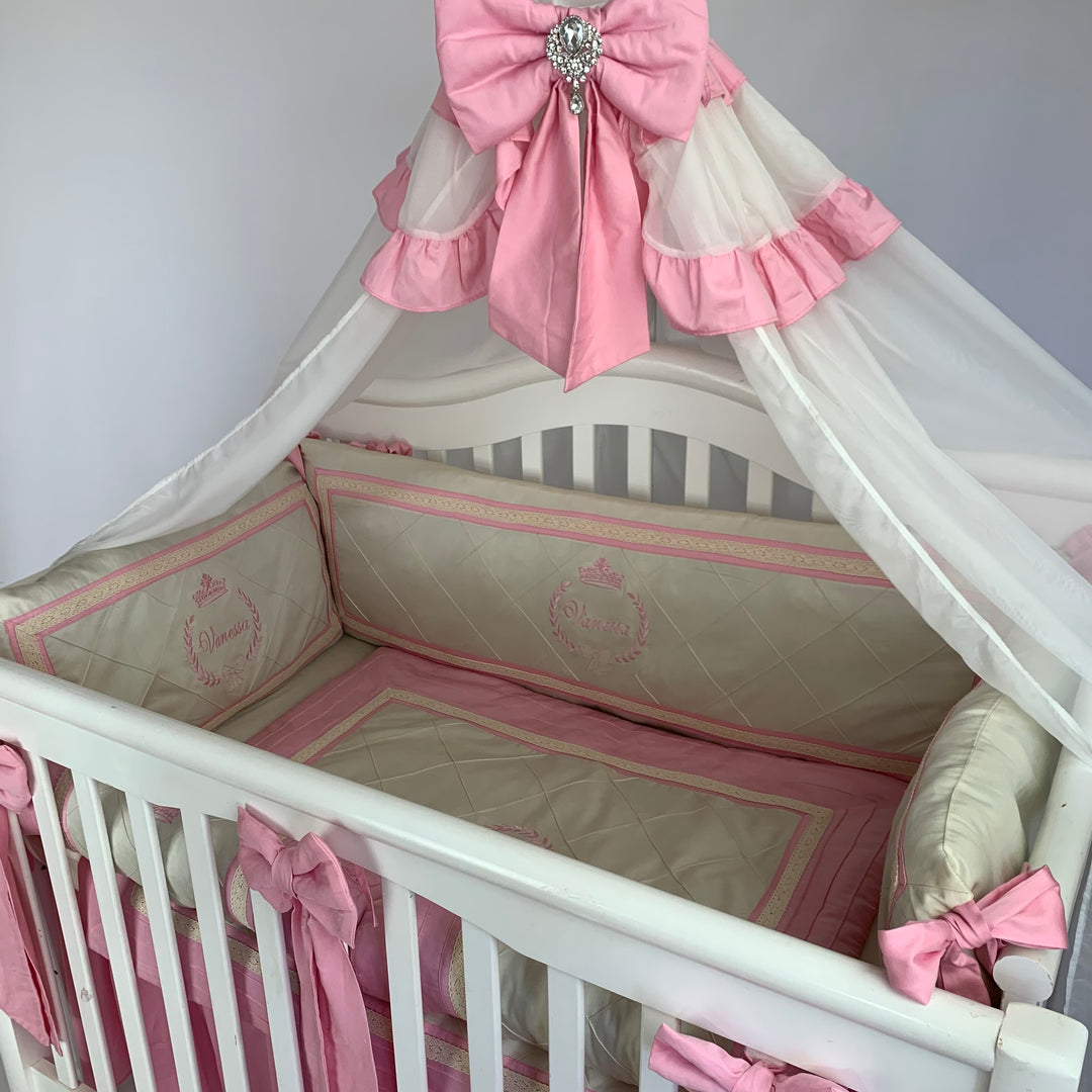 Luxury pink and cream baby bedding set with quilted textures and lace trim