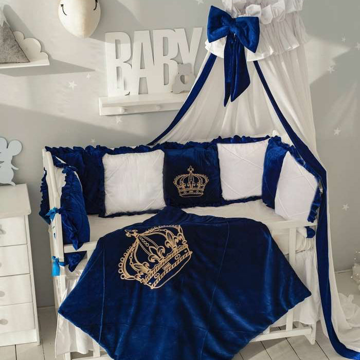 blue and white crib set with royal crown design nursery.
