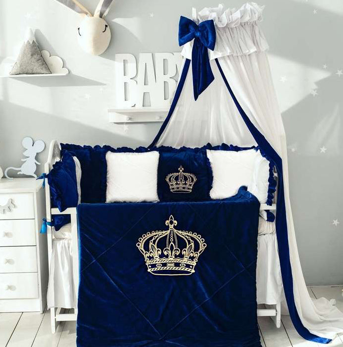 Nav blue crib set with white canopy and crown design in a nursery
