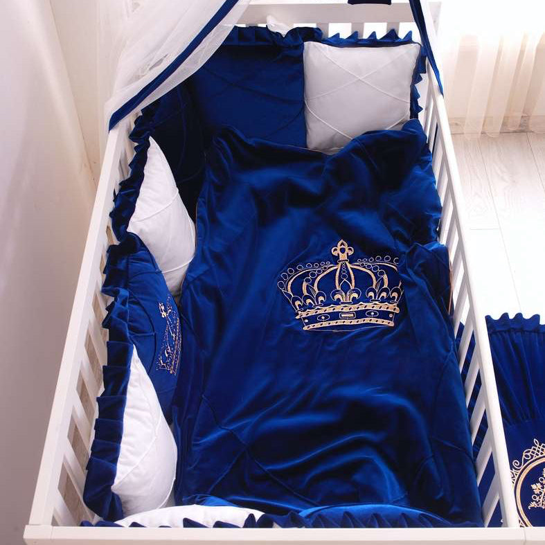 Blue crib set with white accents in a crib