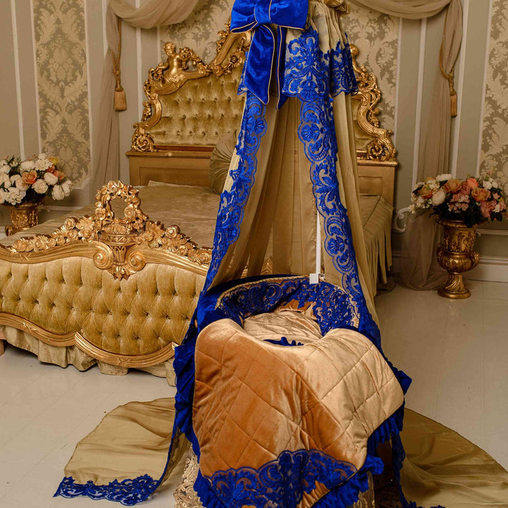 Decorative crib with blue canopy and gold accents in an elegant room.
