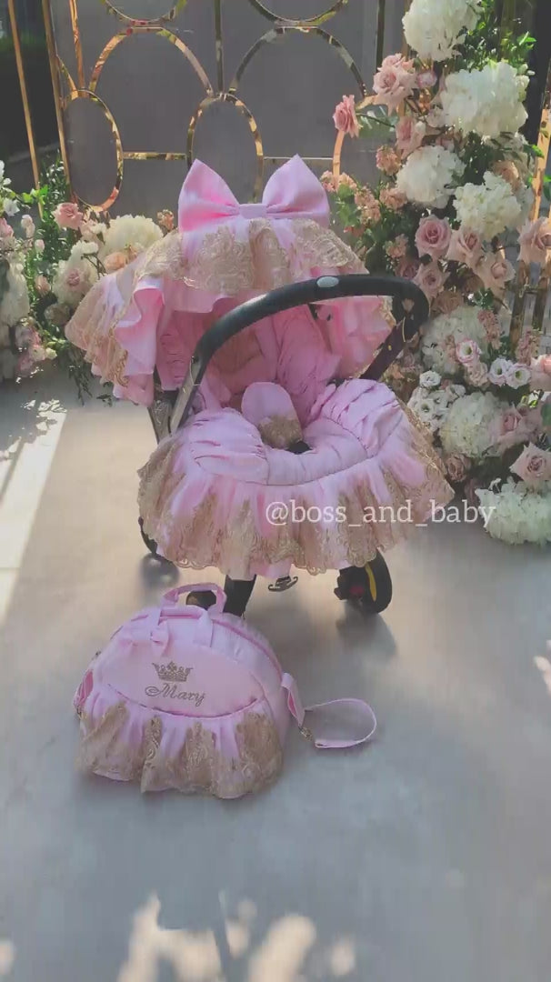 Video showing luxury pink baby car seat cover set with gold lace, ruffled design, and matching accessories
